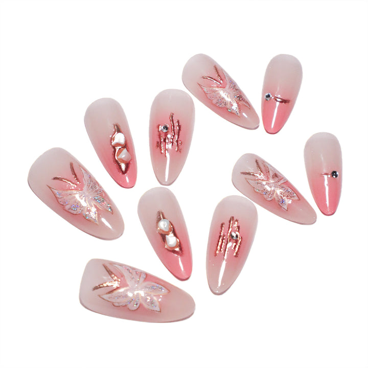 Artificial nail extensions with floral motifs and glitter accents Bowlift