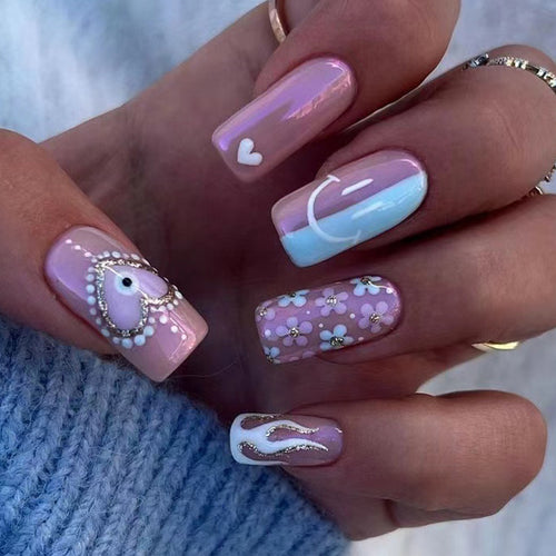 Artful nail art with floral accents and glitter embellishments Bowlift