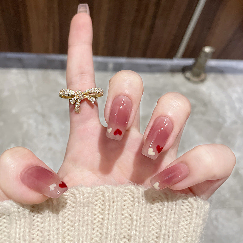 Artificial nails with heart accent and glamorous decorations Bowlift