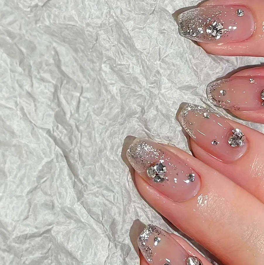 Glamorous artificial nails with glitter and rhinestone embellishments Bowlift