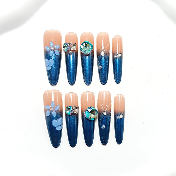 Artificial nails in elegant design with artistic decorations and glitter accents Bowlift