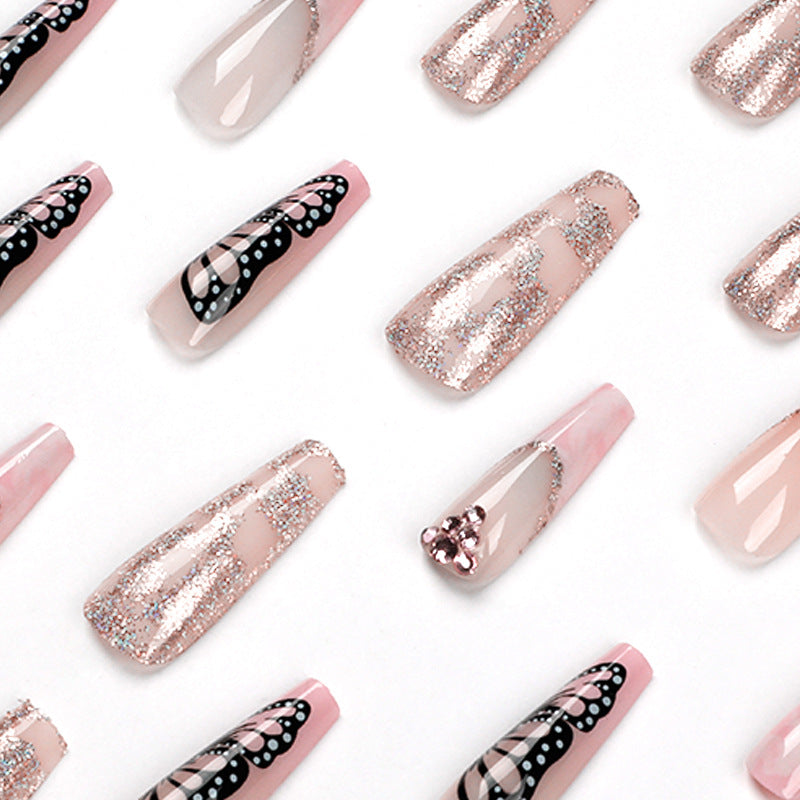 Glamorous nail extensions with beautiful butterfly motifs and glitter accents Bowlift