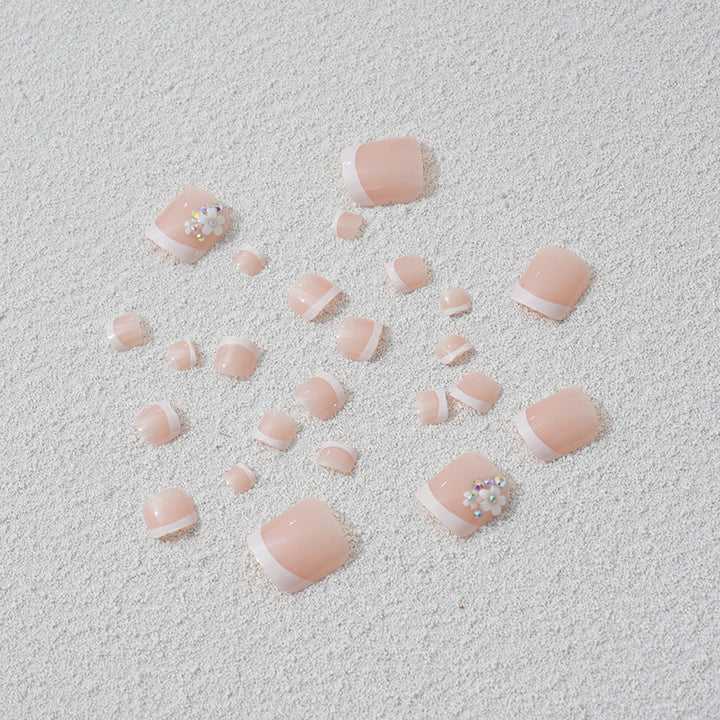 Artificial nail set with elegant French tip design and sparkling accents Bowlift