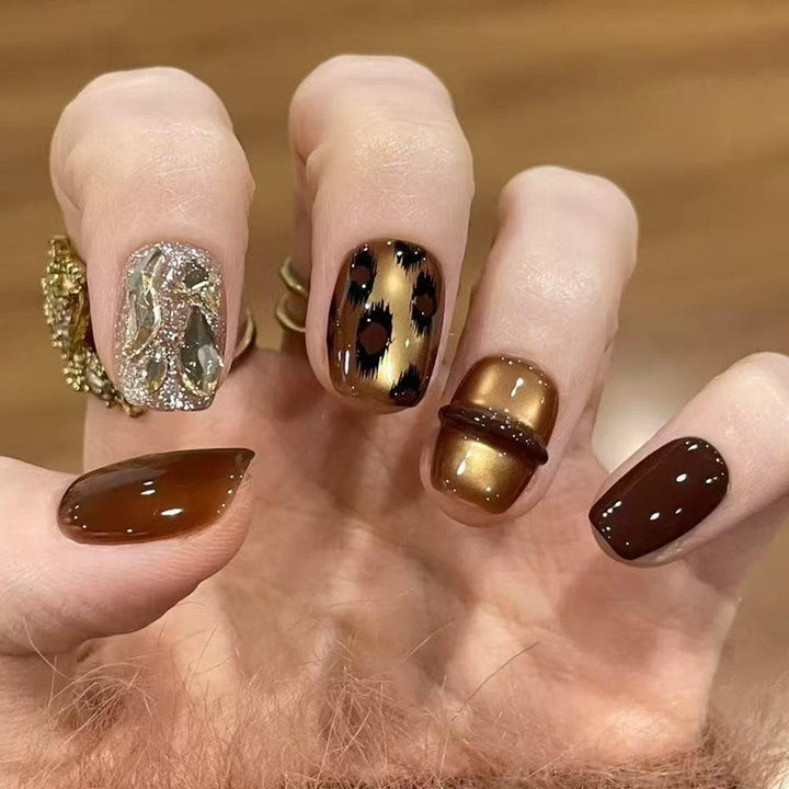 Glamorous artificial nails with animal design and glitter accents Bowlift