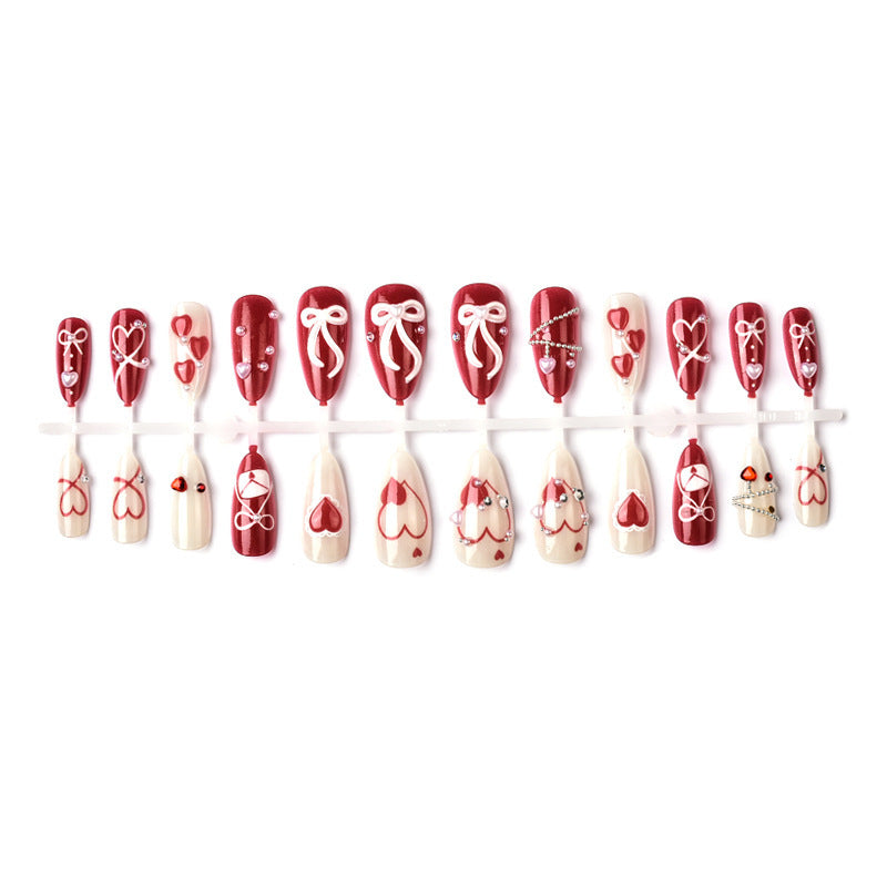 Glamorous artificial nail set with romantic heart design and elegant embellishments Bowlift