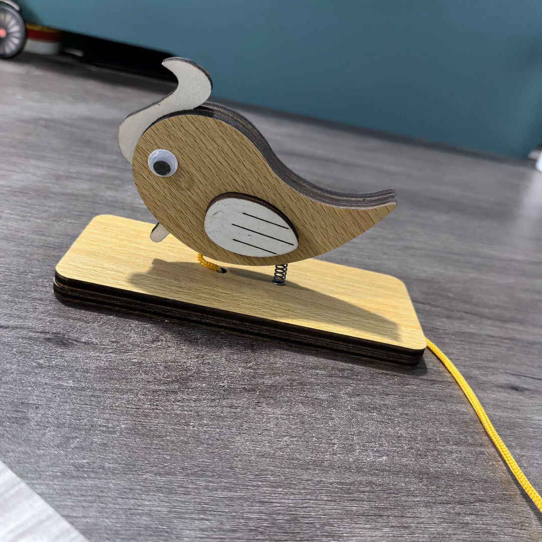 Unisex nan movable wooden bird table figure made of plywood with spiral spring and pull line Bowlift