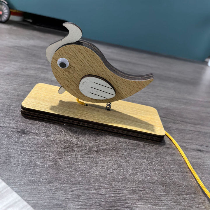 Unisex nan movable wooden bird table figure made of plywood with spiral spring and pull line Bowlift