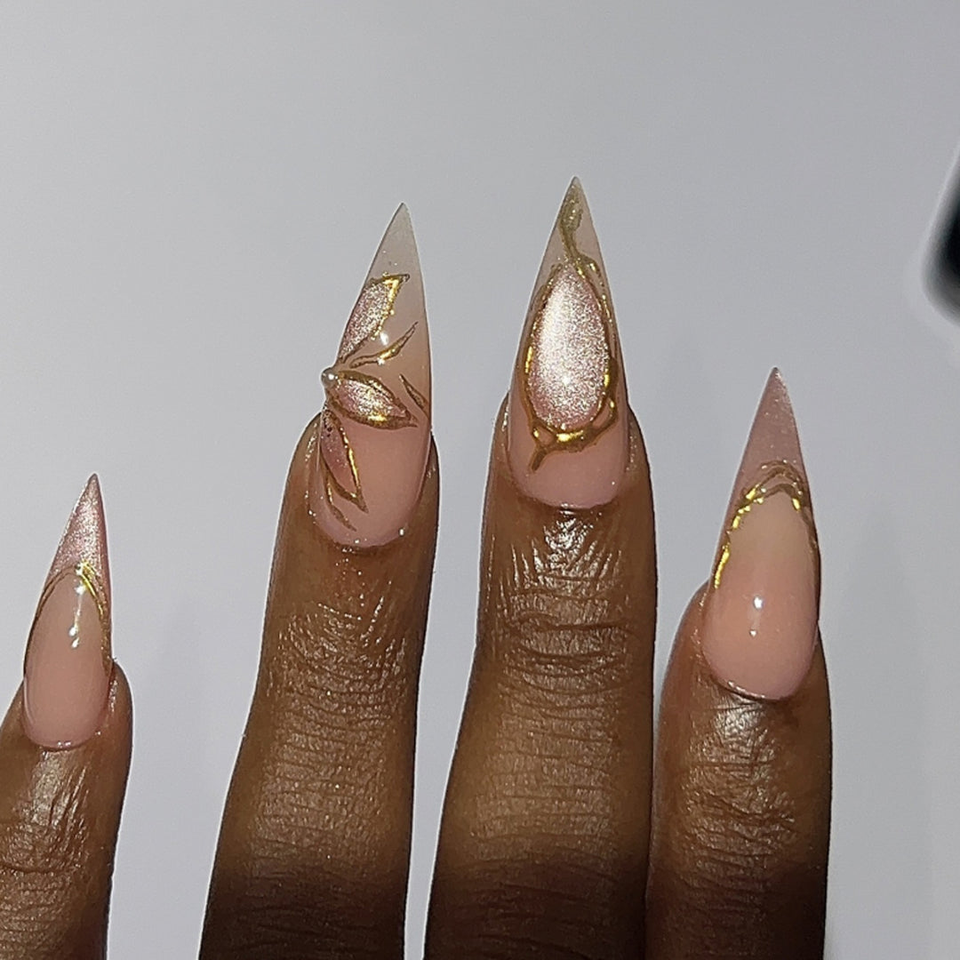 Artful Stiletto Nails with Gold Accents Bowlift
