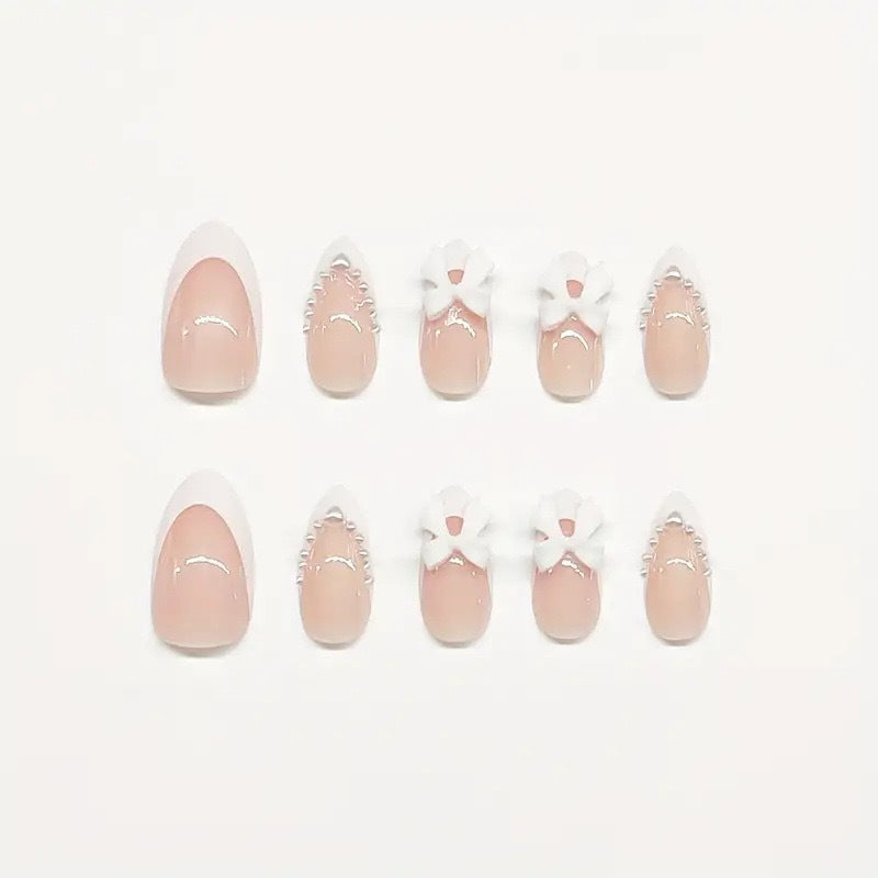 Artistic Press-On Nail Design with Bow Accents Bowlift