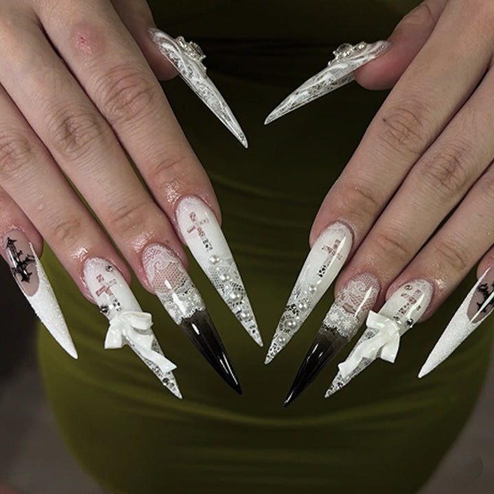 Artful stiletto nails with unique 3D elements and glitter accents Bowlift