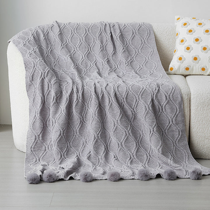 Ladies knit blanket with decorative pom poms Bowlift