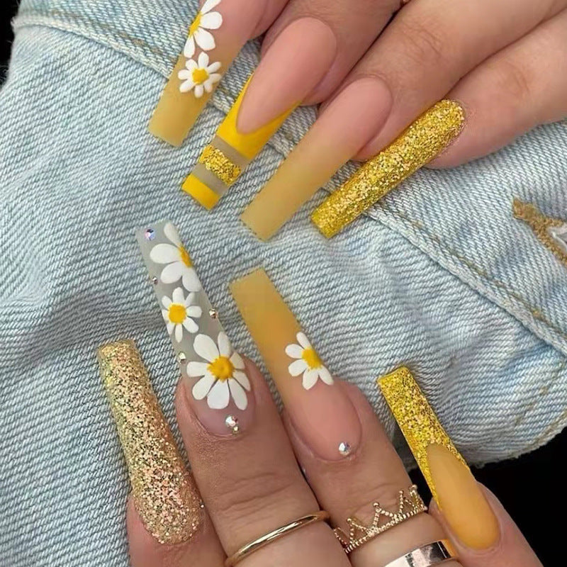 Artificial nail set with colorful sunflower designs and glittering accents Bowlift