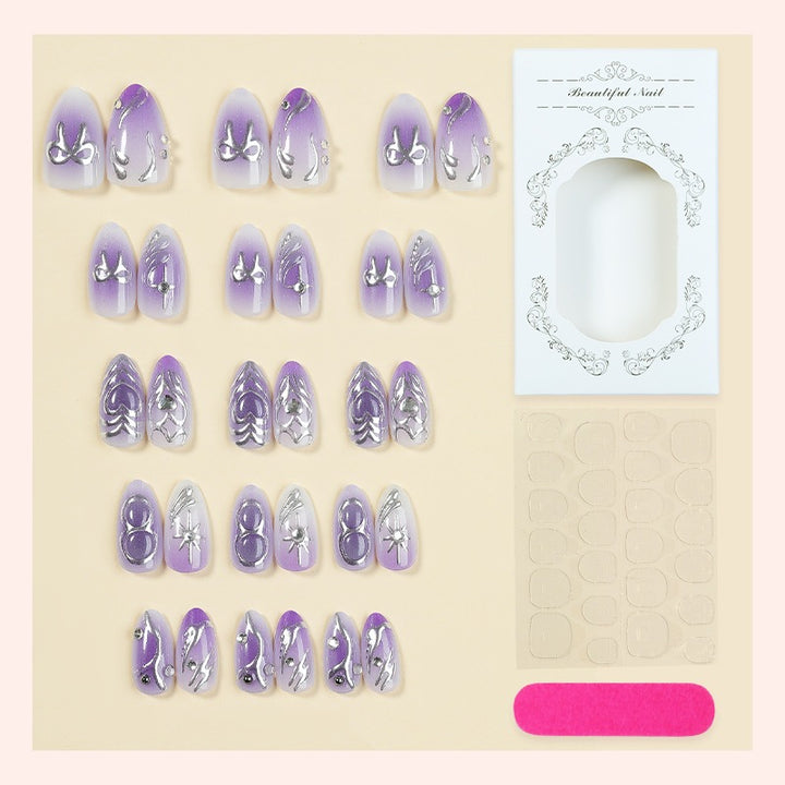 Acrylic nail set with elegant ombre design and delicate embellishments Bowlift