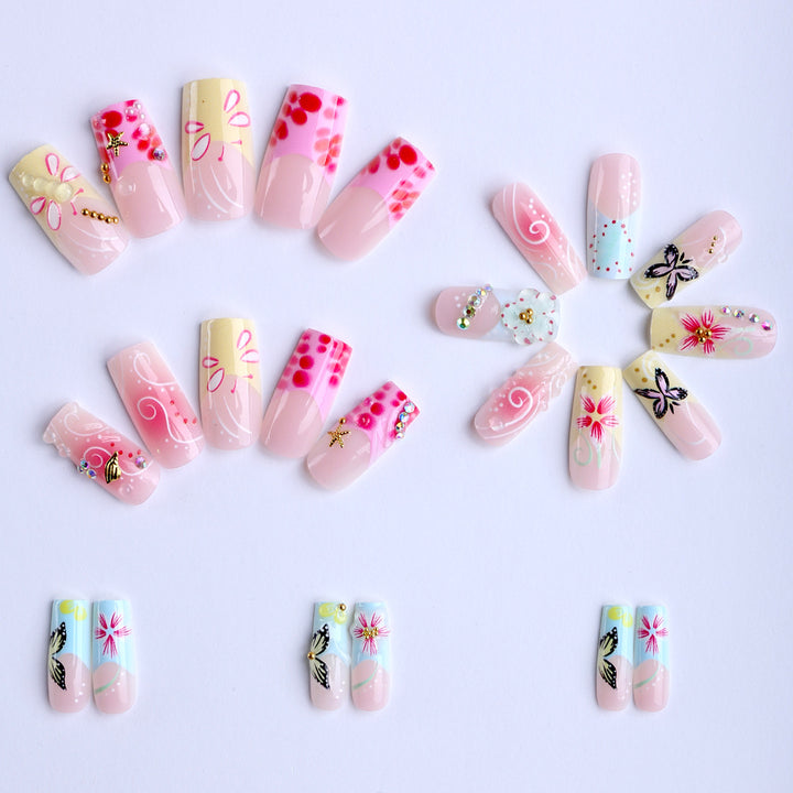 Artistic nails with floral accents and glitter clusters Bowlift