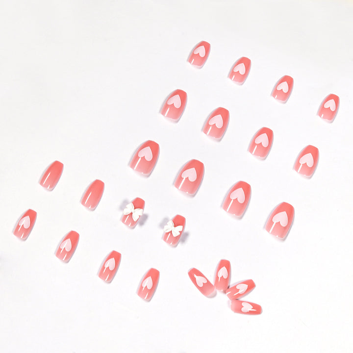 Artistic acrylic nails with heart and bow motifs Bowlift