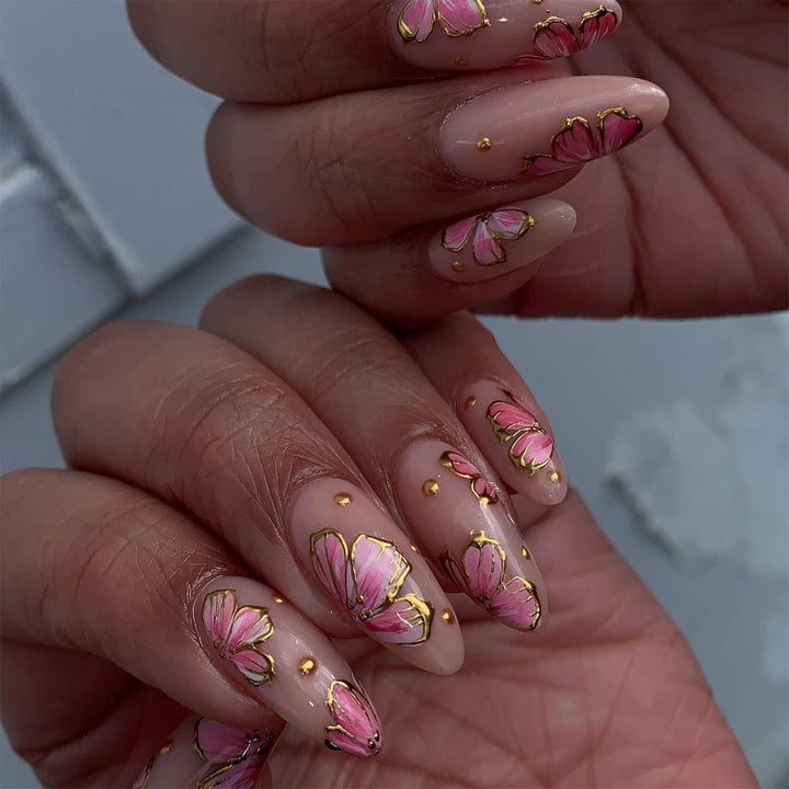 Artful nail art with elegant floral designs and gold accents Bowlift