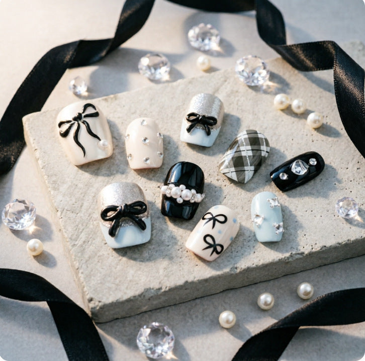 Artificial nails with elegant bows and rhinestones Bowlift