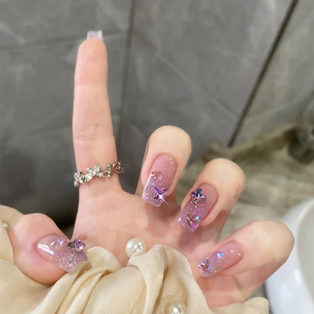 Glamorous artificial nails with glitter and floral accents Bowlift
