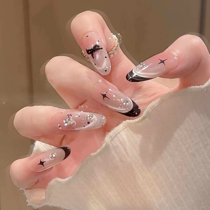 Nail art set with elegant black and white design and sparkling applications Bowlift