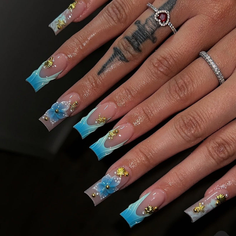Artful nail art with floral accents and glitter effects Bowlift