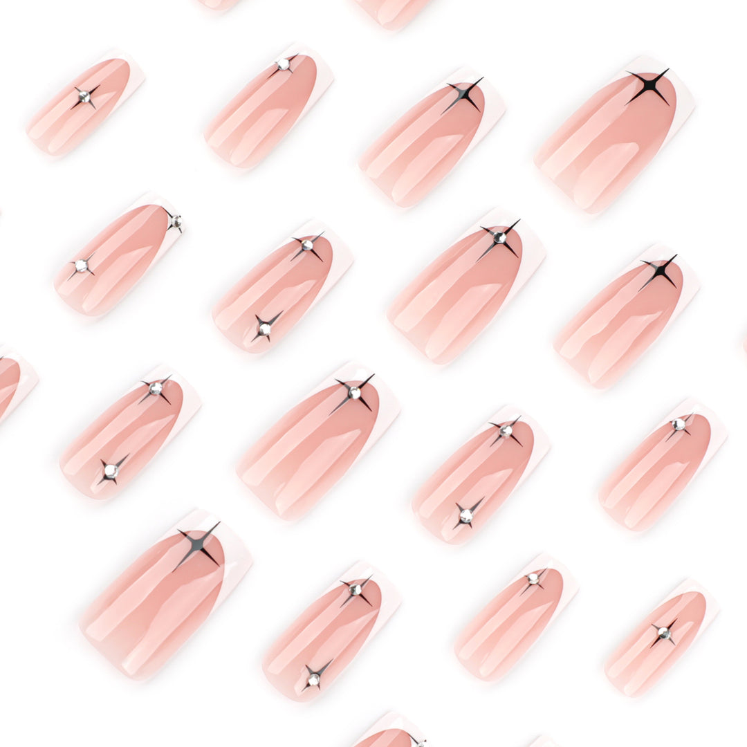 Artificial nail extensions with elegant French tip and glitter accents Bowlift