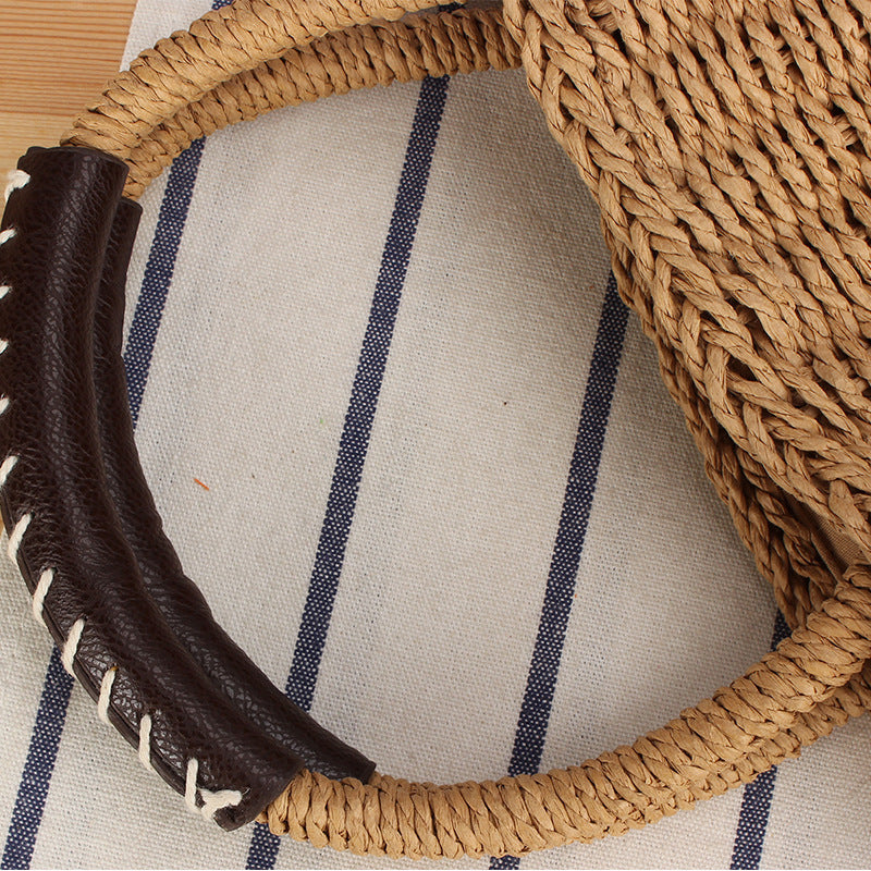 Basket bag made of woven natural material with leather handles Bowlift