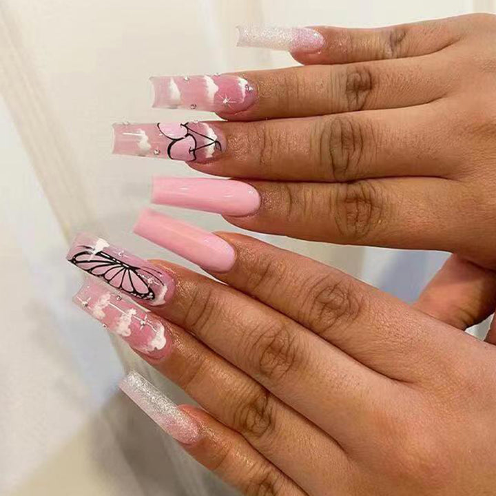 Artificial nail set with romantic butterfly designs and glitter accents Bowlift