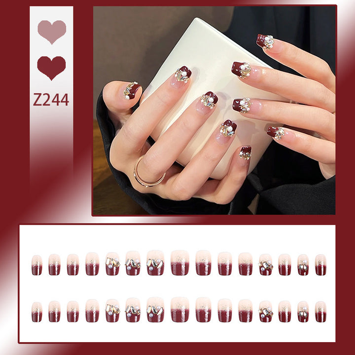 Glamorous artificial nails with decorative pearl and glitter embellishments Bowlift