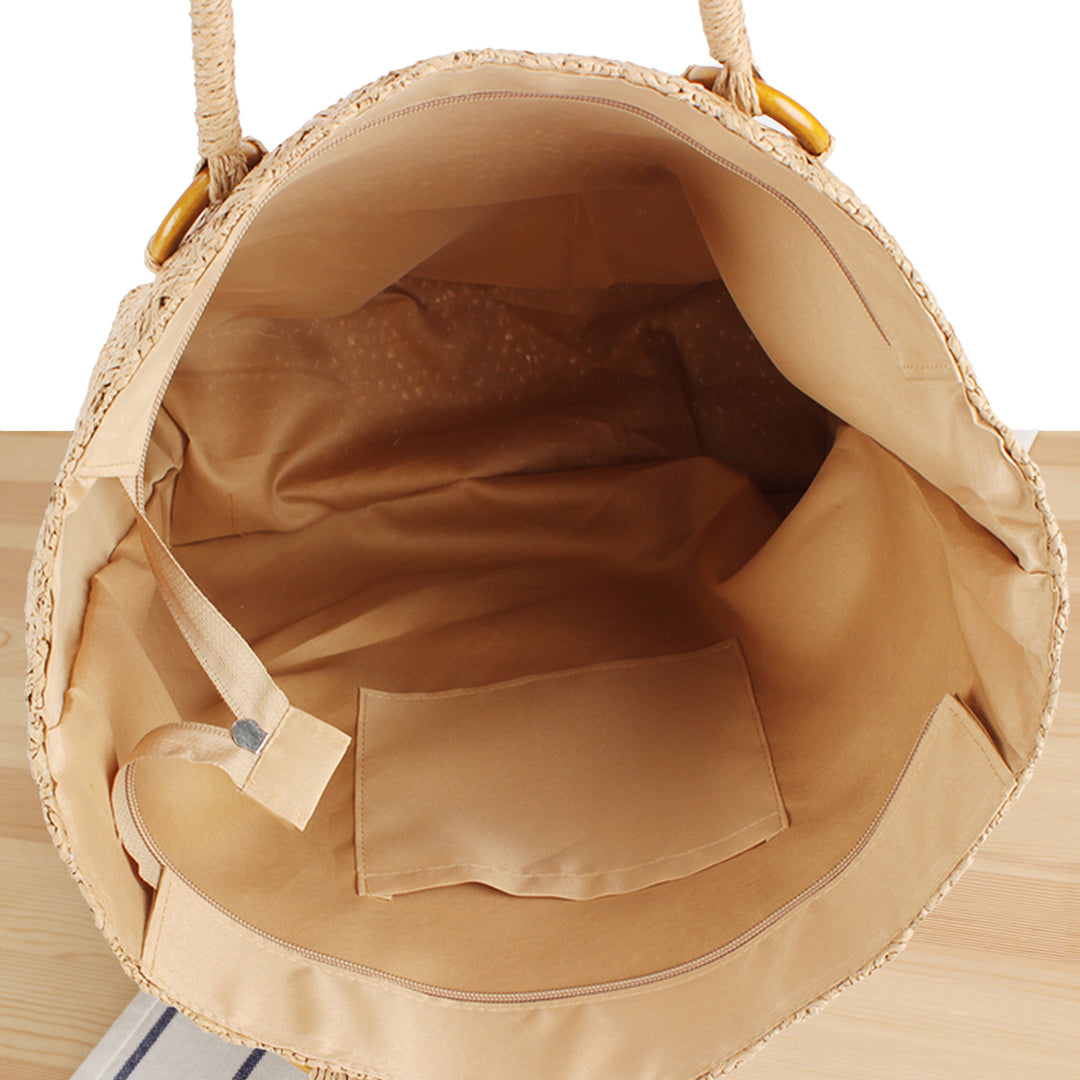 Beach bag made of natural woven material with sturdy carry handles Bowlift