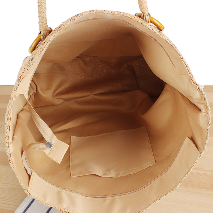 Beach bag made of natural woven material with sturdy carry handles Bowlift