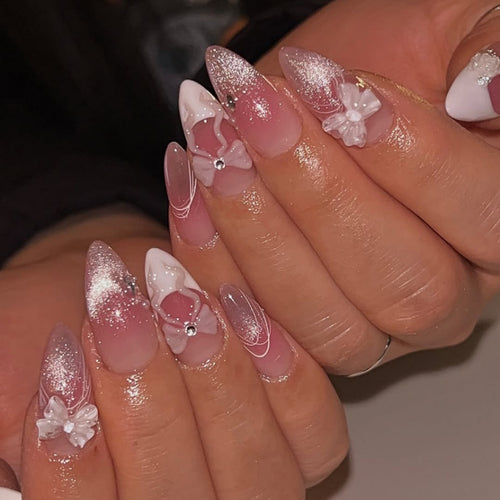 Artful acrylic nails with floral design and glitter embellishment Bowlift