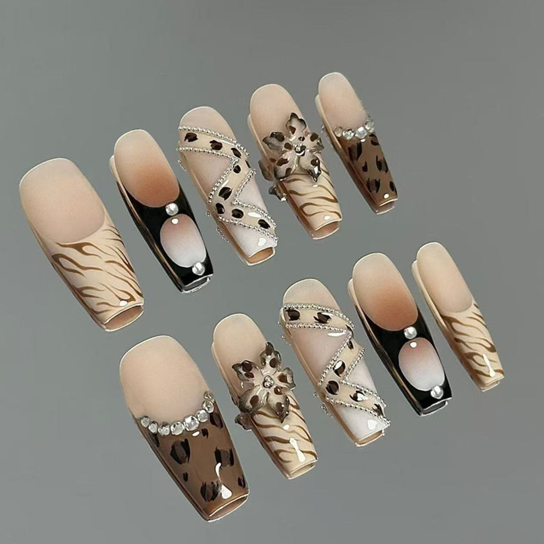 Artificial nail set with glamorous floral designs and creative glitter accents Bowlift
