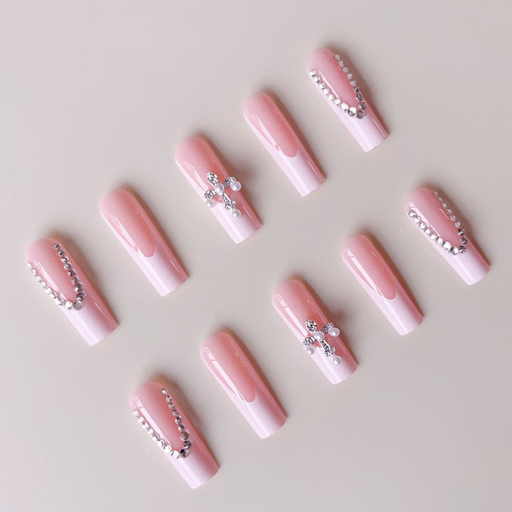 Acrylic nail set with glamorous rhinestone decorations and elegant French tips Bowlift