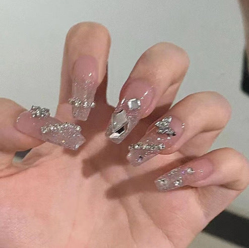 Artistic Nail Art with Glitter and Flower Applications Bowlift
