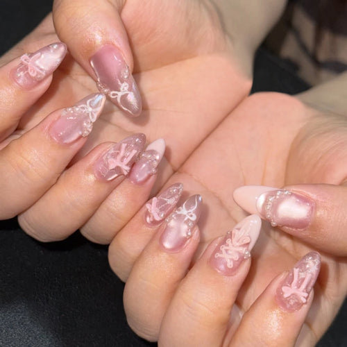 Artful nail extensions with delicate bow motifs Bowlift