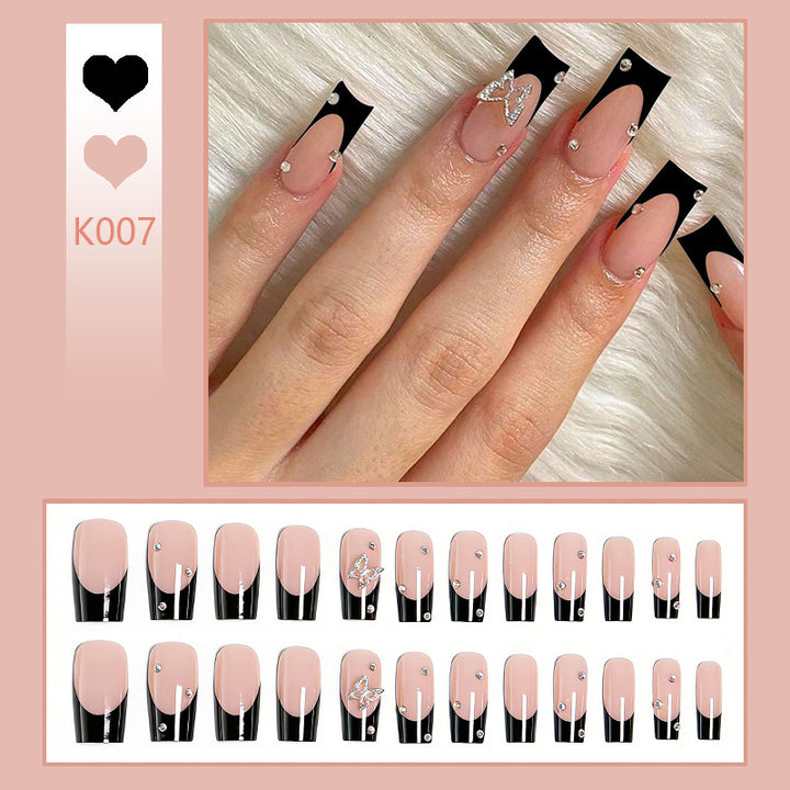 Acrylic nail set with elegant black and white design and glitter accents Bowlift