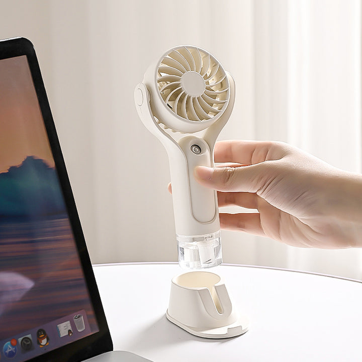 Unisex portable handheld fan with tiltable head, foldable stand and USB charging station Bowlift
