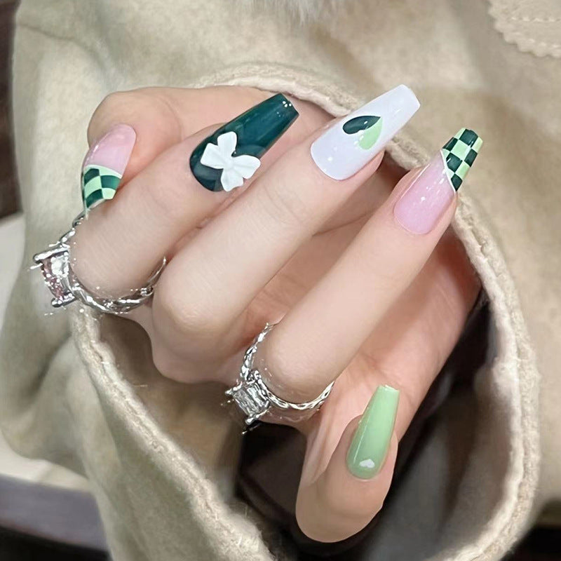 Artificial nail extensions with creative design and glitter accents Bowlift