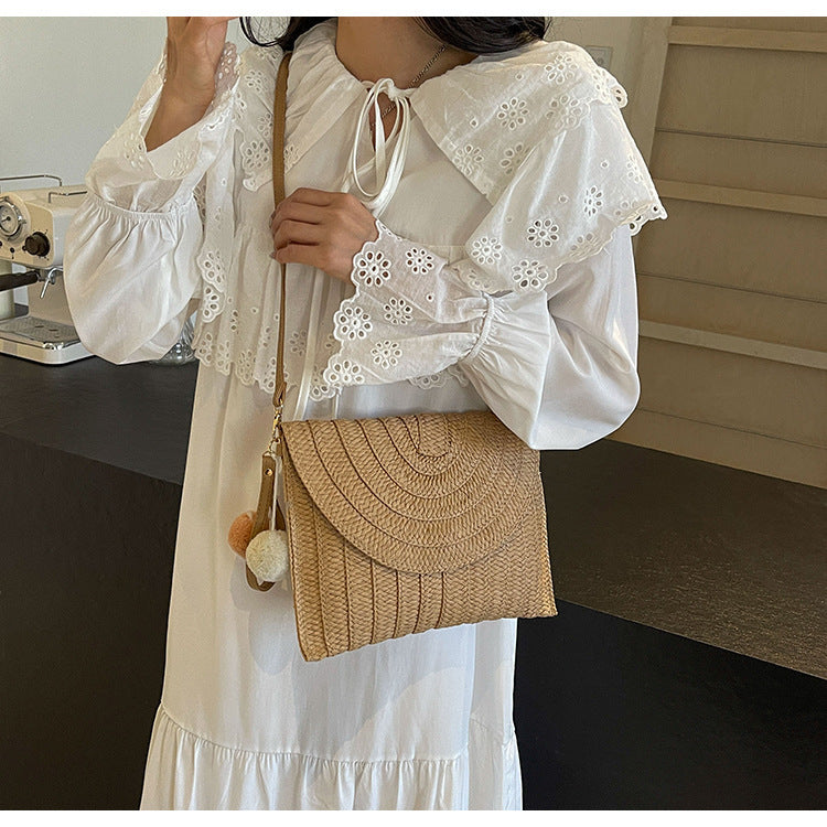 Braided shoulder bag with creative pom poms Bowlift