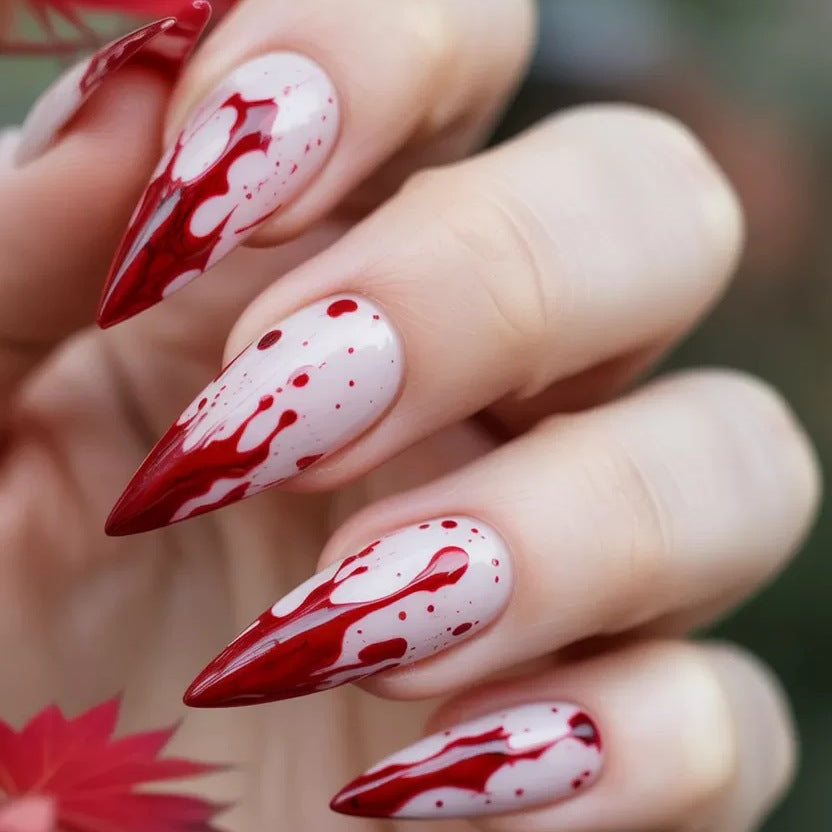 Artificial nail set with blood red inspired design and pointed accents Bowlift
