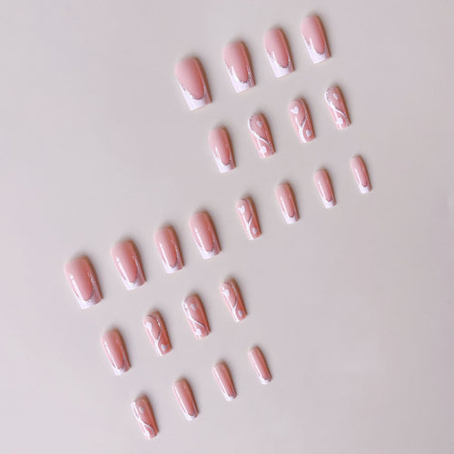 Artificial nail set with romantic heart design and glitter accents Bowlift