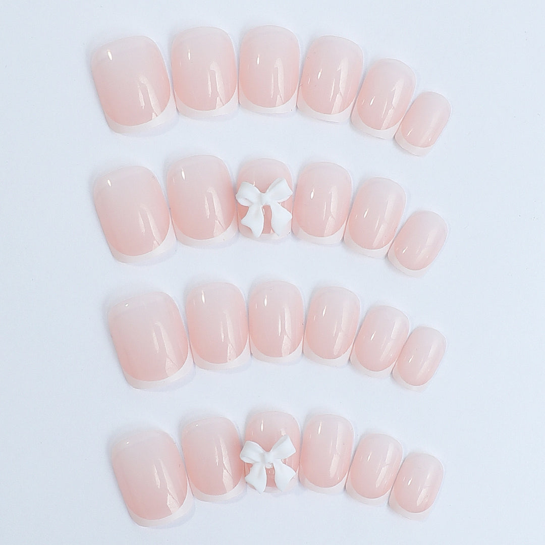 Nail set with elegant French tips and romantic floral decorations Bowlift