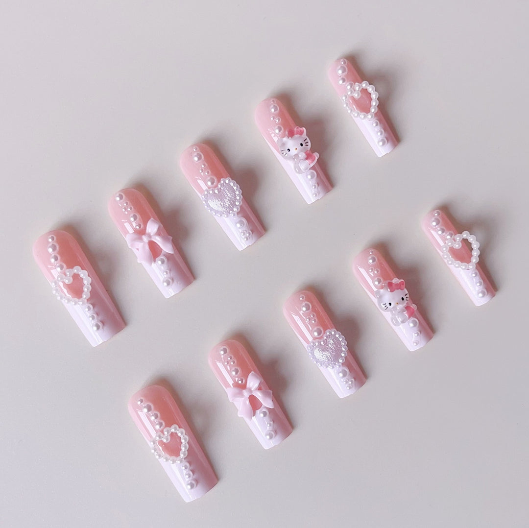 Artificial nail set with playful 3D care and pearl decorations Bowlift