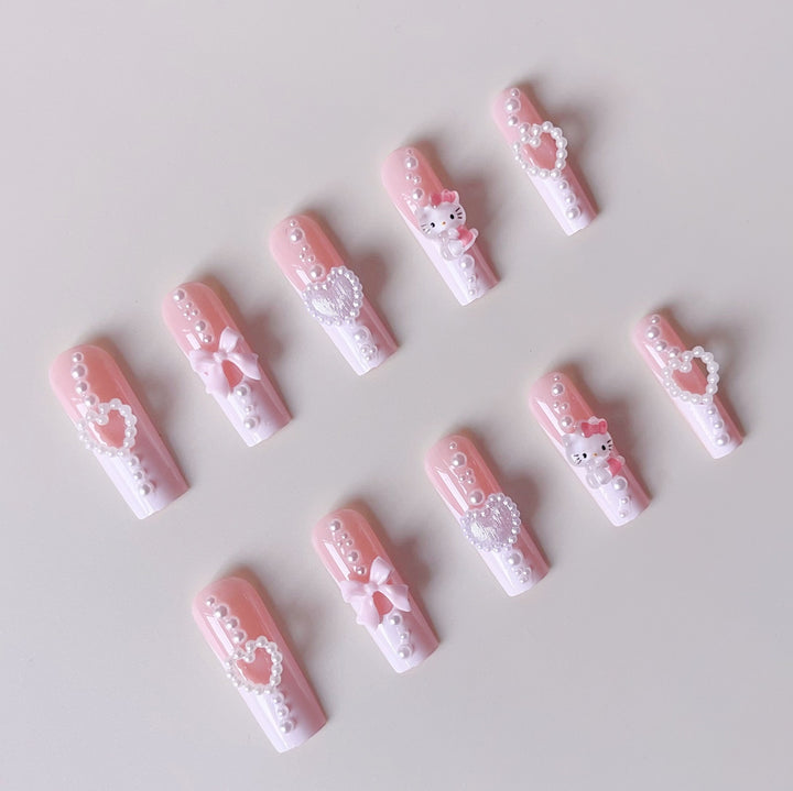 Artificial nail set with playful 3D care and pearl decorations Bowlift