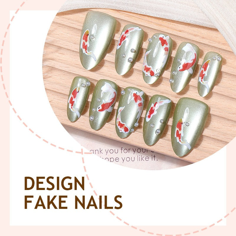 Artificial nail set with filigree koi fish designs and glitter accents Bowlift