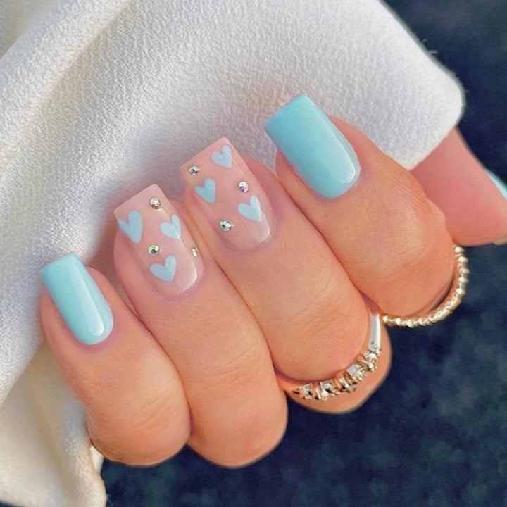 Nail art with heart designs and glitter accents Bowlift