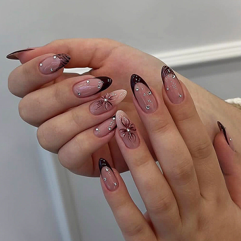 Acrylic nail set with elegant glitter and flower accents Bowlift