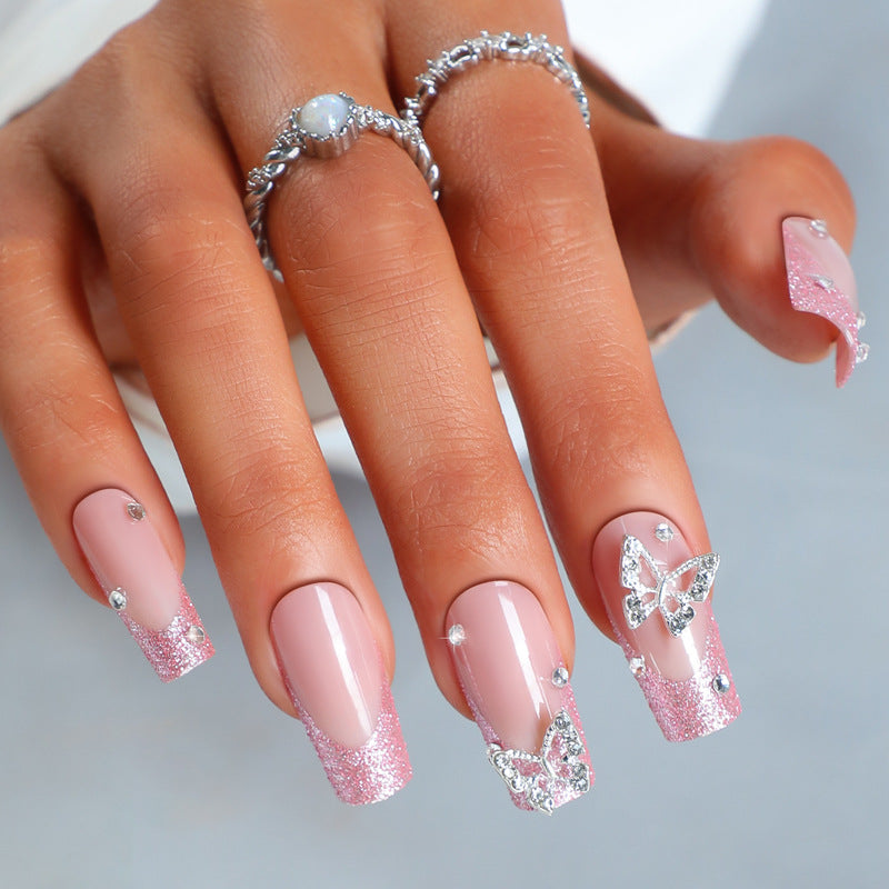 Acrylic nail set with sparkling glitter accents and elegant butterfly motifs Bowlift