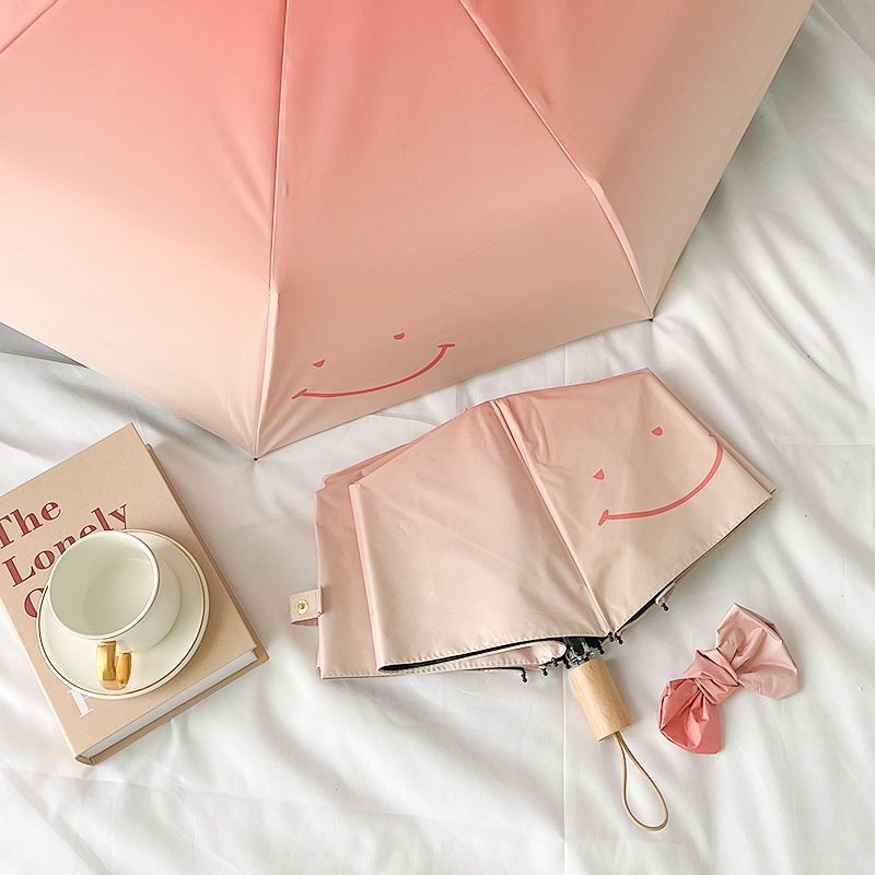 Women's foldable umbrella with playful design and handy wooden handle Bowlift