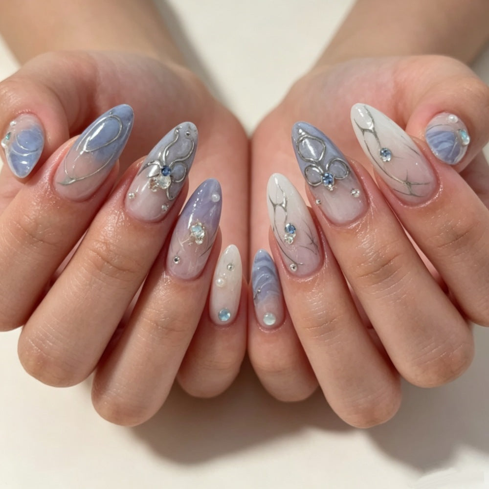 Artistic Press-On Nail Design with Floral and Gem Accents Bowlift
